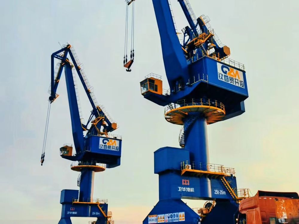 Harbour cranes silhouetted at dusk