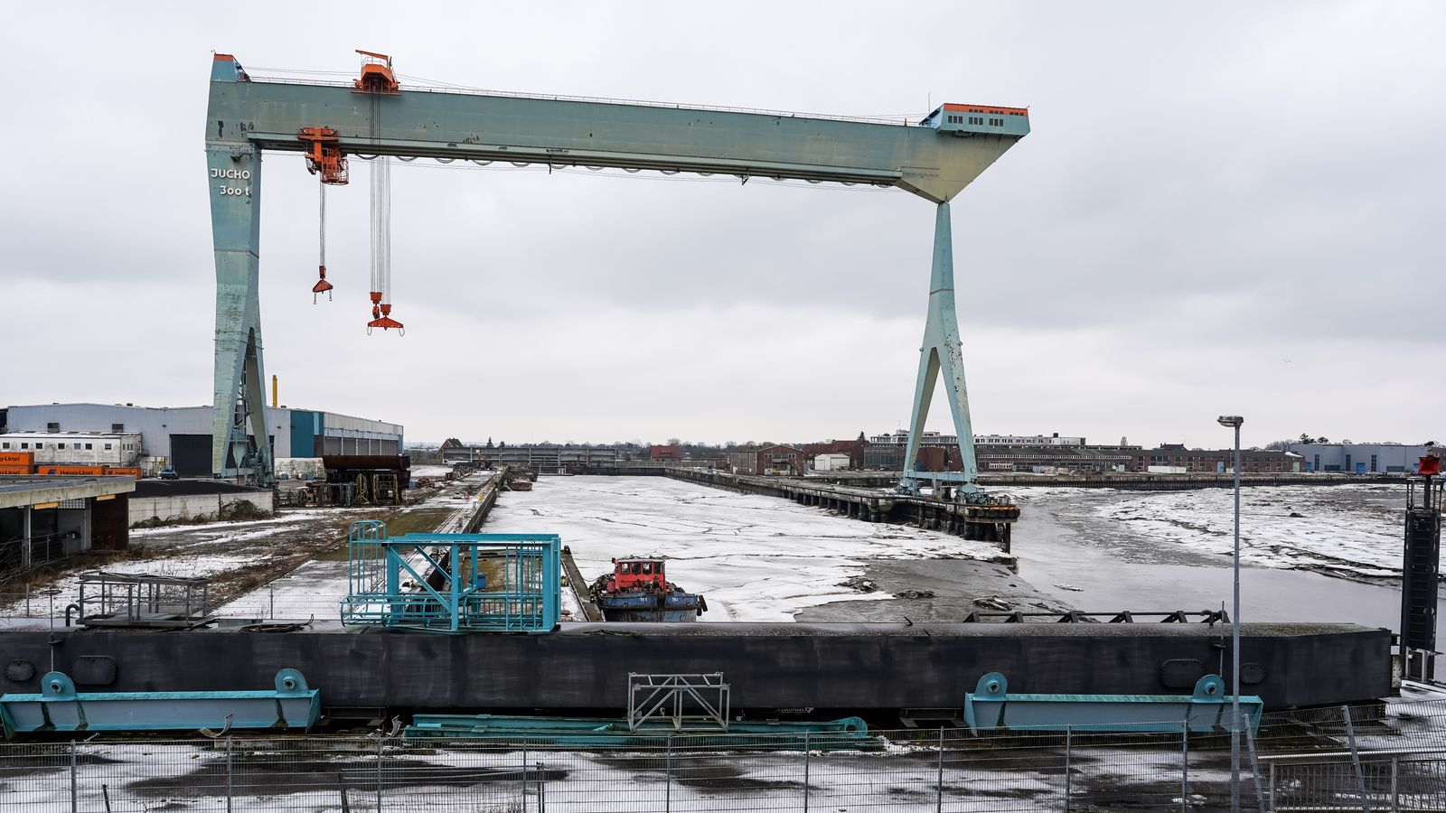 Double-girder gantry crane spanning a shipyard dock