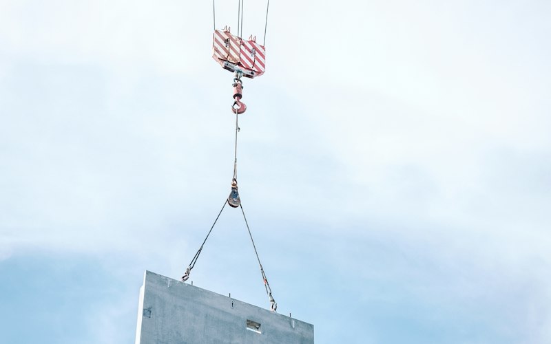 Heavy steel load being transferred across an industrial yard